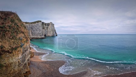 Photo for Sightseeing view to the wonderful cliffs of Etretat washed by the waves of the blue sea water, La Manche Channel. Famous Falaise d'Aval coastline in Normandy, Franc - Royalty Free Image