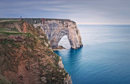 Photo for Sightseeing view to the Porte d'Aval natural arch cliff washed by Atlantic ocean waters at Etretat, Normandy, France. Beautiful coastline scenery with famous Falaise d'Aval - Royalty Free Image