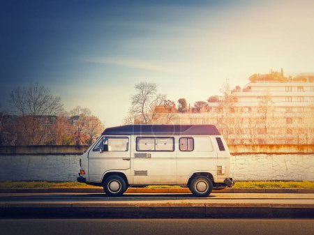 Photo for Old van parked on the edge of the street in the sunset sky background, Asnieres sur Seine, Paris suburb, France - Royalty Free Image