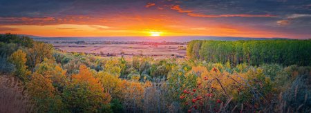 Photo for Autumn evening over the valley. Beautiful fall panorama with the multicolored forest and orange october sunset - Royalty Free Image