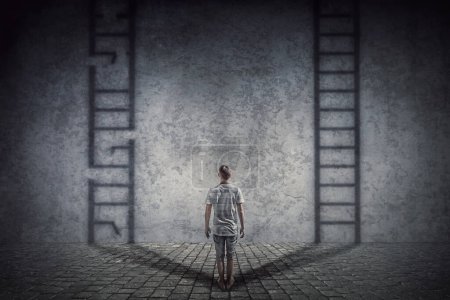 Photo for Person stands in front of a wall casting two ladder shadows with one broken on the left and another ready to use on the right. Dilemma and choice concept between good and bad - Royalty Free Image