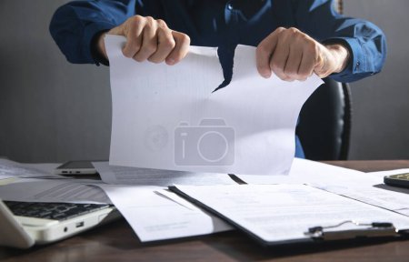 Businessman breaking contract at office.