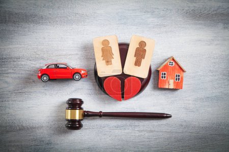 Male and female wooden symbols, house, car, broken heart and judge gavel. 