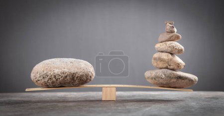 Photo for Balance stones on wooden scales. - Royalty Free Image