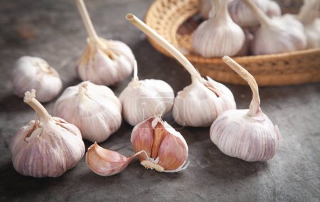 Photo for Garlic bulbs on the stone background. - Royalty Free Image