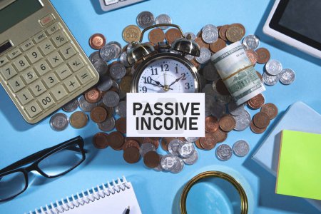 Passive Income on credit card with a coins and other objects.