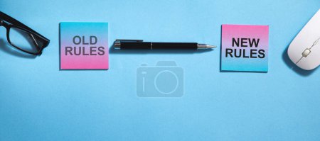 Téléchargez les photos : Anciennes règles et nouvelles règles texte sur des notes collantes avec des objets d'affaires. - en image libre de droit