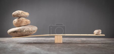 Photo for Balance stones on wooden scales. - Royalty Free Image
