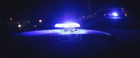 Photo for Blue light flasher. Police car at night time in the city - Royalty Free Image