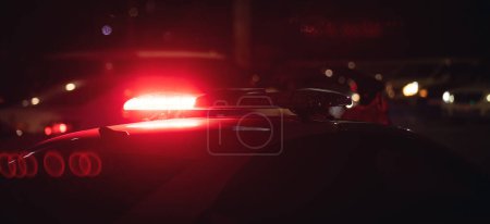 Photo for Red light flasher. Police car at night time in the city - Royalty Free Image