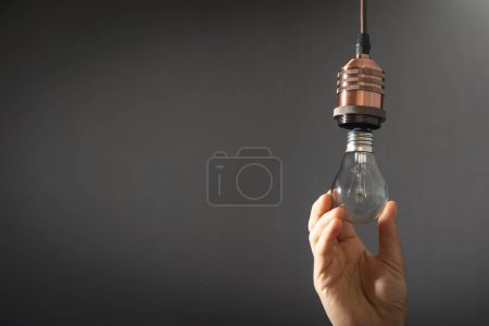 Photo for Man changing light bulb at home. - Royalty Free Image