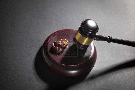 Photo for Judge gavel with a wedding rings. Divorce proceedings - Royalty Free Image