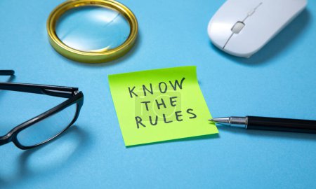 Photo for Know The Rules on sticky note with a business objects on the blue background. - Royalty Free Image