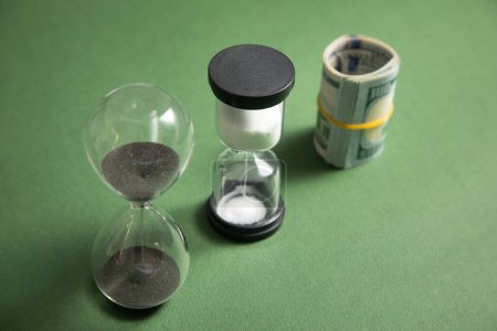 Foto de Reloj de arena y dólar. El tiempo es dinero - Imagen libre de derechos
