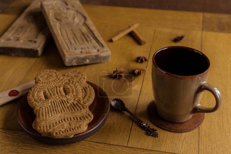 Coffee and Dutch spiced bisquit called speculaas. Concept for the Sinterklaas tradition..