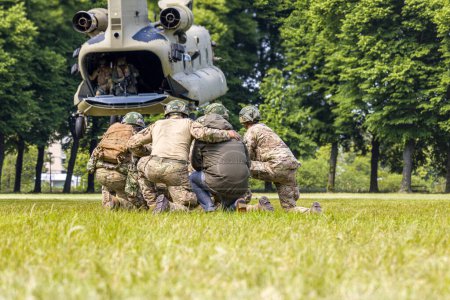 Photo for 's Hertogenbosch Netherlands june 6 2023: Soldiers and a civilian are being picked up by a RNLAF CH-47 Chinook - Royalty Free Image