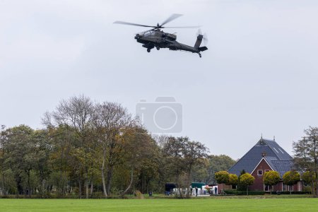 Photo for Drachten Netherlands, november 10 2022: A AH-64 Apache hovering over a Dutch farm, Falcon Autumn exercise - Royalty Free Image