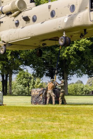 Photo for 's Hertogenbosch Netherlands june 6 2023: RNLAF CH-47 Chinook airlifting cargo during public exercise - Royalty Free Image