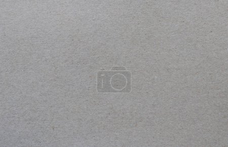 Gray recycled carton sheet background. Paper texture with fibers.