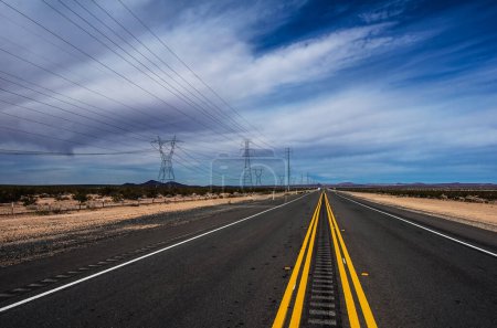 Photo for In the middle of the street that crosses the desert of Mojave. - Royalty Free Image