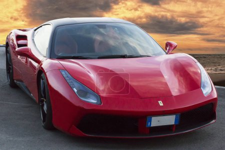 Photo for Rome, Italy August 23, 2023: Fast and luxury model sports car Ferrari 488 GTB from Ferrari Italian automaker located in fantastic golden sunset - Royalty Free Image