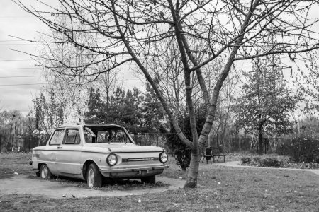 Photo for Photography on theme super old retro car Zaporozhets stands in park with flat tires, photo consisting of very old retro car with broken glass after an accident to park, old retro car at park no people - Royalty Free Image