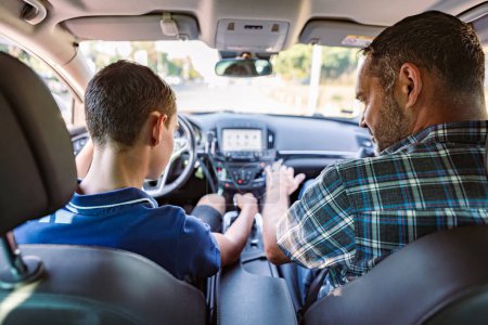 Photo for Driving instructor sitting in a car with his student and explain to him driving basics, traffic rules and how to properly prepare himself for a drive. View from inside. - Royalty Free Image