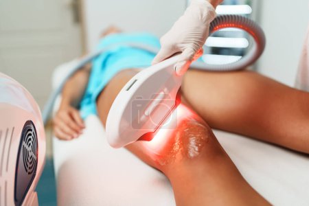 Photo for Beautiful young woman receiving professional laser hair removal treatment. Modern beauty epilation. - Royalty Free Image