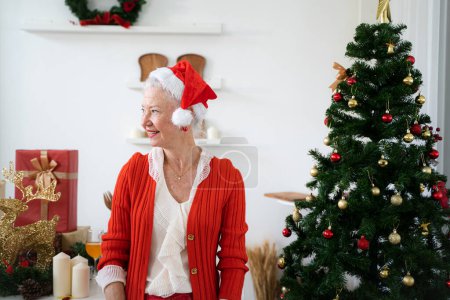 Photo for Old woman celebrate xmas holidays together with family - Royalty Free Image
