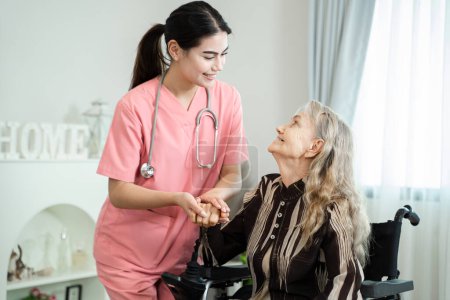 Medical care for the senior at home concept,Friendly nurse taking care elderly woman patient careful,give support empathy.