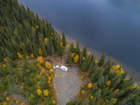 Photo for Aerial view of camping caravan near river flowing to lake Gautstraesk and surrouding autumn landscape along Ammarnas National Park in Lapland Sweden - Royalty Free Image