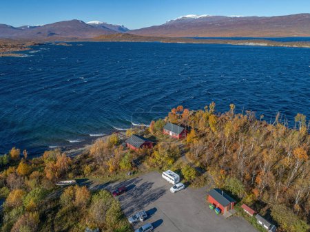 Photo for Aerial footage Car Camping Caravan parking by lake from Abisko national park towards Bjoerkliden during swedish lapland fall colors ruska indian summer - Royalty Free Image
