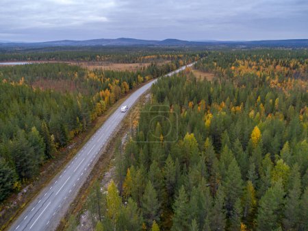 Photo for Drone footgage Car Camping Caravan driving road lake Swedish Lapland fall ruska colors National Park Sweden. - Royalty Free Image