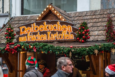 Photo for Koblenz Germany 17.12.2022 imbiss selling food potato pancakes made from fresh potatos Traditional Christmas market booth sign. - Royalty Free Image
