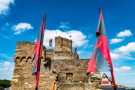 Photo for Brodenbach Germany 05.08.2018 Entrance Area with flags of the Ehrenburg Castle Rhineland Palatinate. - Royalty Free Image