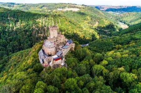 Photo for Aerial view rock with medieval castle Ehrenburg on it near moselle river in Brodenbach with forest hills. - Royalty Free Image