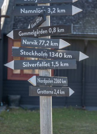 Photo for Signpost Abisko Sweden Arctic Circle indicates distance and direction to various towns and sites of interest like Northpole and Stockholm - Royalty Free Image