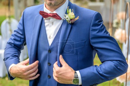 Photo for Rose boutonniere flower groom wedding outfit coat with bow-tie . - Royalty Free Image