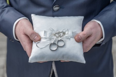 Photo for Two wedding rings on a ceremonial cushion pillow beautifull decorated. - Royalty Free Image