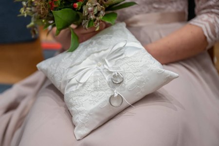 Photo for Two wedding rings on a ceremonial cushion pillow beautifull decorated. - Royalty Free Image