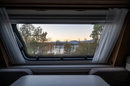 Foto de Atardecer temporada de otoño en Abisko a través de una ventana de caravana con el lago Tornetraesk en el fondo Laponia sueca Suecia. - Imagen libre de derechos