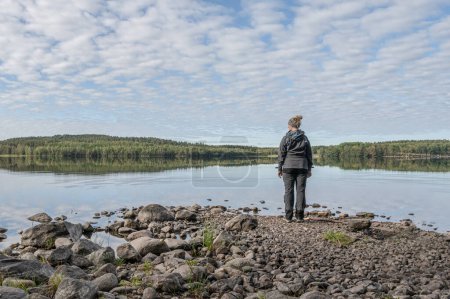 Téléchargez les photos : Fille debout au lac Ragnerudssjoen miroir dans Dalsland Suède belle forêt naturelle pinetree suédois. - en image libre de droit