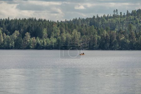 Photo for Couple Kayaking Boat tour on lake Ragnerudssjoen in Dalsland Sweden beautiful nature forest pinetrees. - Royalty Free Image