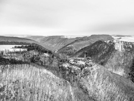 Photo for Aerial view rock with medieval castle Ehrenburg on it near moselle river in Brodenbach with white winter snow wonderland forest hills - Royalty Free Image