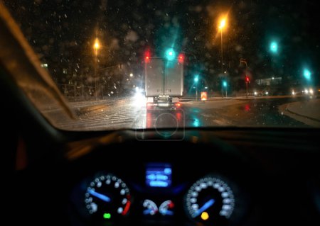 Photo for Blurred background. City view, lights, falling snow, night, street, bokeh spots of headlights of moving cars winter scenery Lantern light, snowfall - Royalty Free Image