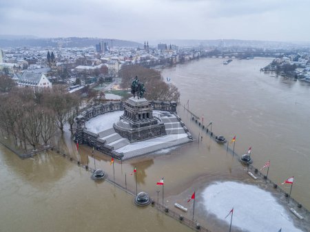 Flooding high water in Koblenz City Germany historic monument German Corner in winter where the rivers rhine and mosele flow together.
