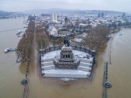Flooding high water in Koblenz City Germany historic monument German Corner in winter where the rivers rhine and mosele flow together.