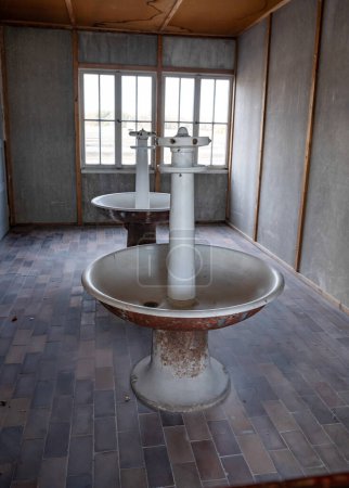 Photo for Munich Germany Interior of living quarters, showing wash stands, at Dachau Concentration Camp, Munich, Germany. - Royalty Free Image
