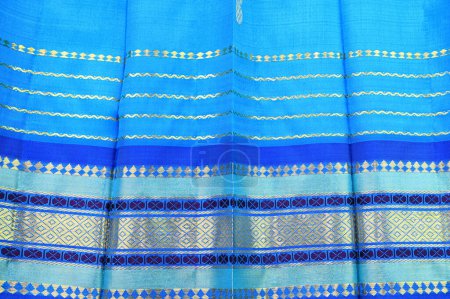Foto de Blue silk sari background with gold colored border - Imagen libre de derechos