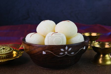 Photo for Rasgulla is an Indian dessert served in a wooden bowl. - Royalty Free Image